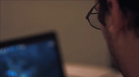 A guy playing at the computer at night. Видео 37539128