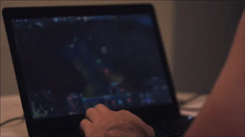 A guy playing at the computer at night. Stock Footage 37539134