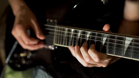 Guy playing electric guitar, close-up, slow Stock-Footage 118884124