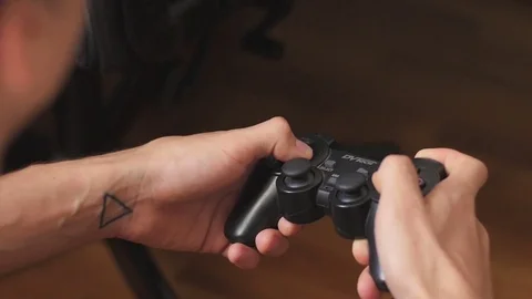 The guy is playing on the gamepad. close-up Stock Footage 81318611
