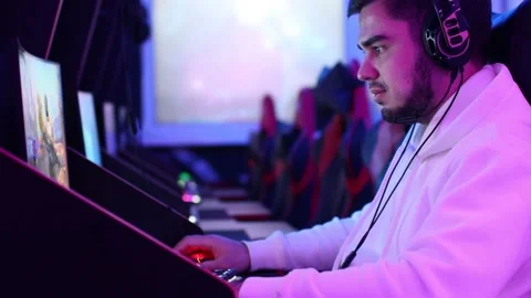 Guy playing gaming game on computer at game club Stock Footage 204029041