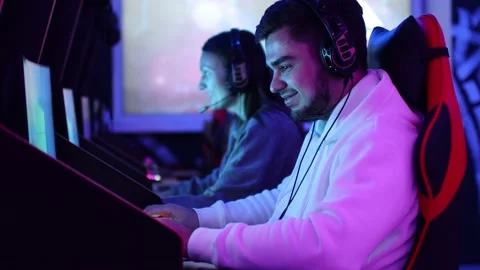 Guy playing gaming game on computer at game club Stock Footage 204029083