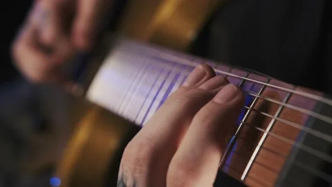 A guy is playing gold electro guitar Stock Footage 156525336