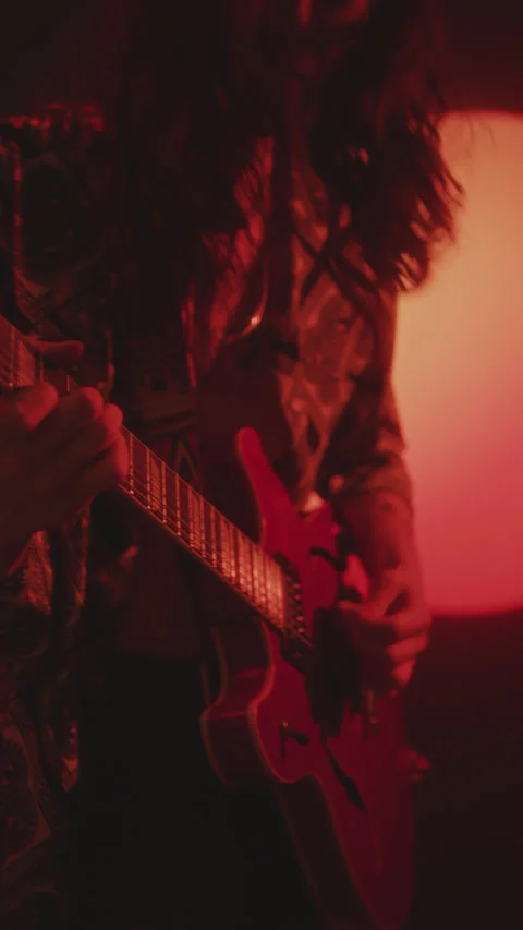 Guy Playing the Guitar and Rocking to Music in Dark Studio with Red Light Stock Footage 272283377