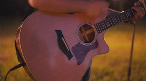 Guy is playing guitar in the evening Stock Footage 53903173