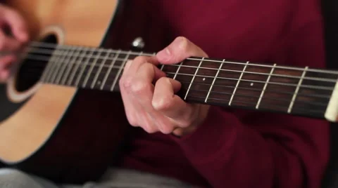 The guy playing the guitar. Video stock 59728800