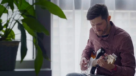 The guy is playing the guitar Stock Footage 127662524