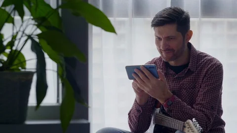 The guy is playing the guitar Stock Footage 127663130
