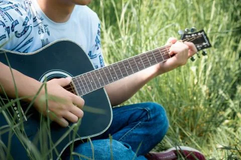 A guy playing a guitar Stock Photos