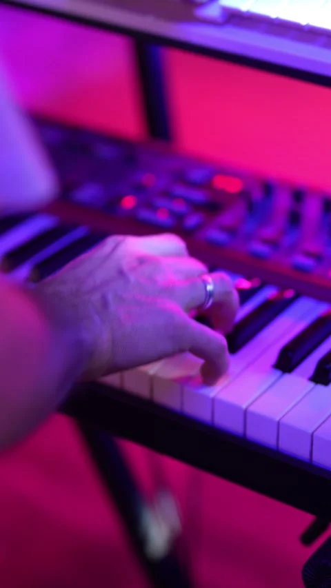 A guy playing a keyboard plays a synthesizer, close-up of his hands Stock Footage 325053306