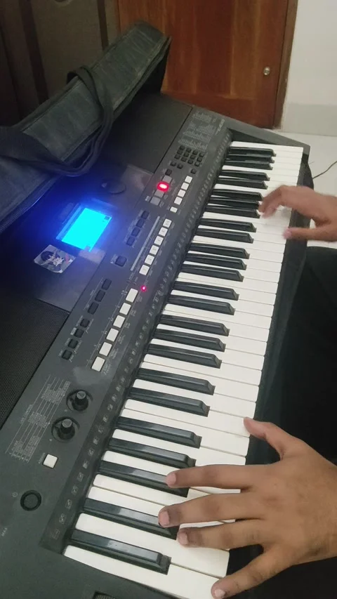 A guy playing a melody on his black keyboard Stock Footage 171418888