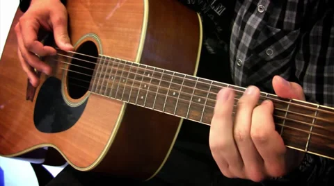 Guy is playing song on guitar Stock Footage 39813811