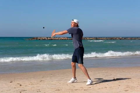 The guy playing tennis on the beach Stock Photos