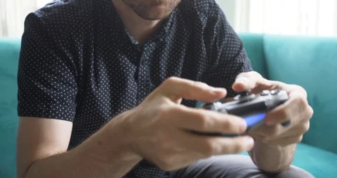 Guy playing video games up close on hands and controller Stock Footage 96004807