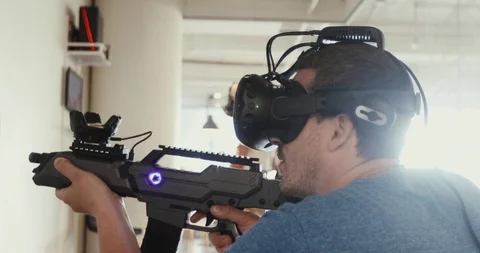 Guy playing VR sniper game with gun and glasses Stock Footage 91895528