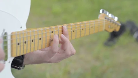 Guy playing a white electric fender guitar Stock Footage 107084350