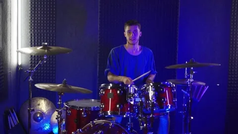 The guy plays the drums. Blue color in the studio. Slow motion Stock Footage 200222979