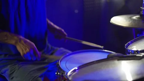 The guy plays the drums, the camera moves from the drums to the face Stock Footage 200222970