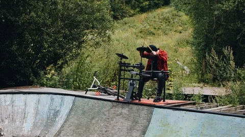 The guy plays drums on the edge of an abandoned pool. atmospheric shots Stock Footage 114519527