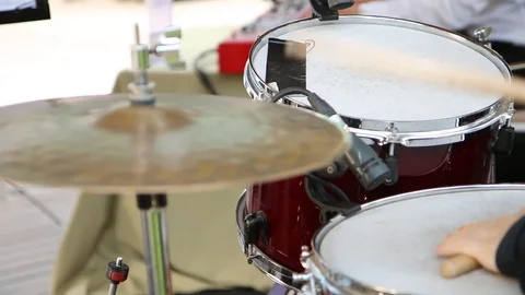 The guy plays the drums. Shooting through the drums Stock Footage 118894836