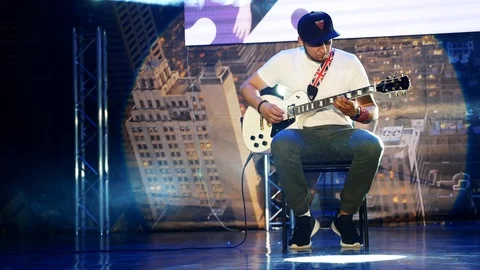 The guy plays the electric guitar on stage Stock Footage 90367442