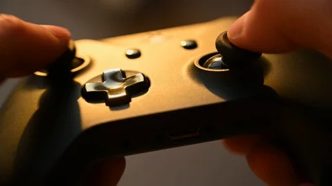 A guy plays a game console Stock Footage 119385345