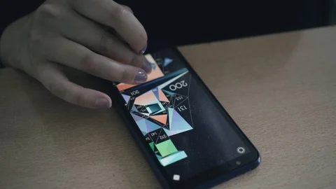 The guy plays the game on his smartphone. Close up. Smartphone is on the table Stock Footage 109186220
