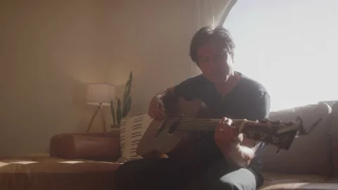 Guy Plays Guitar On Couch Stock Footage 208782778