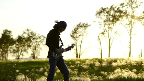 Guy plays guitar on the field Stock Footage 133700773
