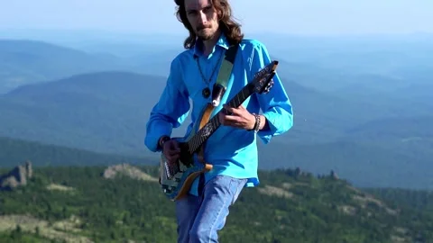 Guy plays guitar on the field Stock Footage 135852201