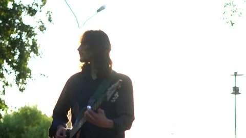 Guy plays guitar on the field 스톡 동영상 136639750