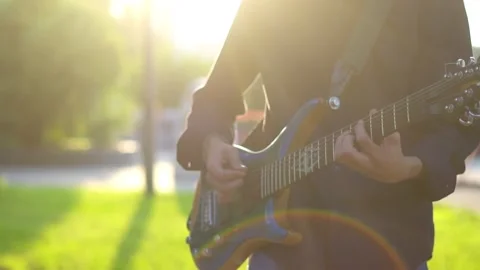 Guy plays guitar on the field Видео 136639842