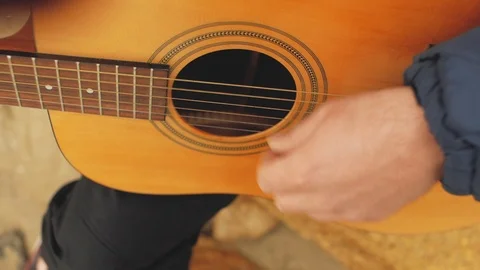 The guy plays the guitar. guitar deck with strings Stock Footage 103445323