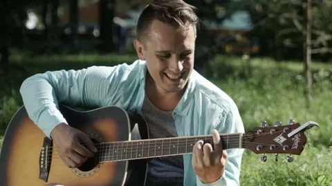 Guy plays the guitar in the sun 库存影片 80797776