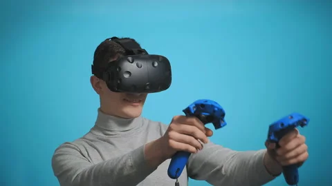 Guy plays with modern virtual reality headset Vídeos de archivo 130892061