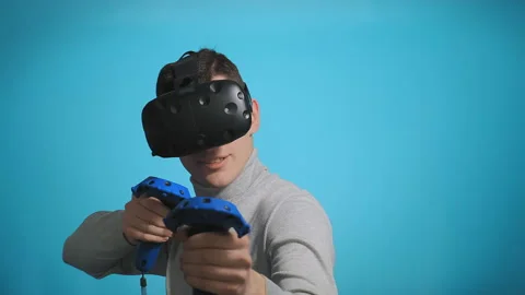 Guy plays with modern VR headset Stockbeeldmateriaal 130892195