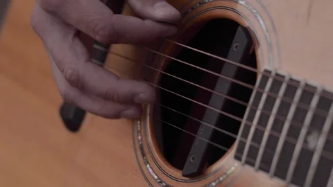 Guy plays picking on an acoutsic guitar Stock Footage 107084453