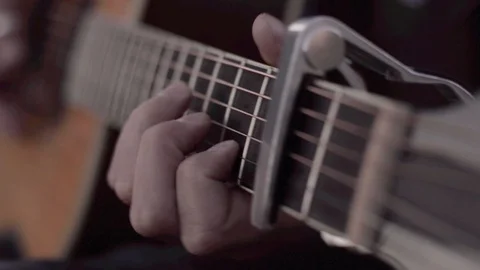 Guy plays strumming on an acoutsic guitar Stock Footage 107084459