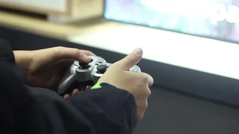 Guy plays using a gamepad Stock Footage 73011372