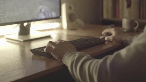 Guy plays a videogame on a PC his hands on a computer mouse and keyboard Stock-Footage 129521636