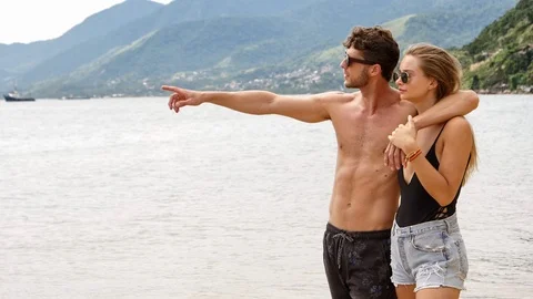 Guy pointing to sea Stock Footage 93995487