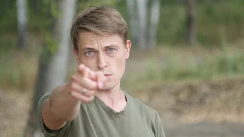 The guy points his finger at the camera and says Hey, you! 動画素材 137847363