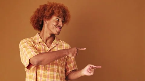 Guy points to the side at pointing fingers to show mockup space, isolated on Stock Footage 255963947