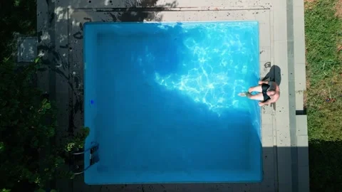 Guy in the pool on a bright sunny day, sporty guy in shorts Stock Footage 251009660