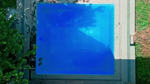 Guy in the pool on a bright sunny day, sporty guy in shorts Video stock 251068293