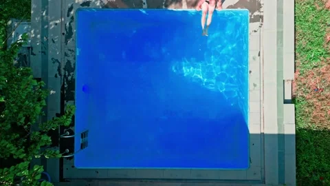 Guy in the pool on a bright sunny day, sporty guy in shorts Stock Footage 251237358