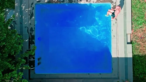 Guy in the pool on a bright sunny day, sporty guy in shorts Stock Footage 251238985