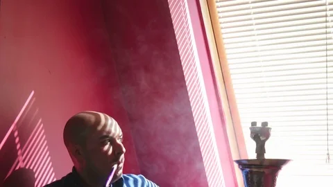 The Guy Portrait Smoking Hookah in a Bar Breath out Smoke Stock Footage 75258266