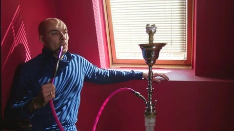 The Guy Portrait Smoking Hookah in a Bar Breath out Smoke Stock Footage 75258272