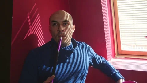 The Guy Portrait Smoking Hookah in a Bar Breath out Smoke Stock Footage 75258358